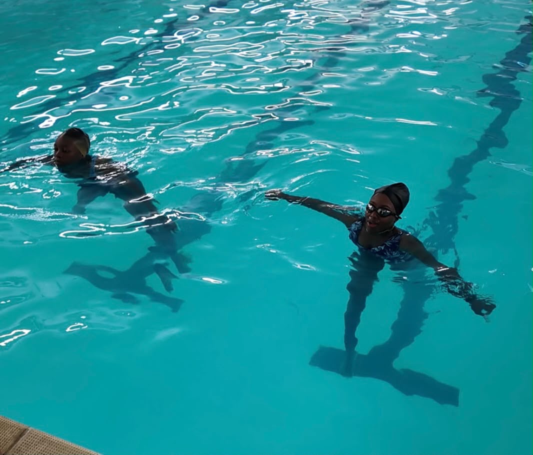 Aqua Jetz instructor coaching an adult learner's kicking technique