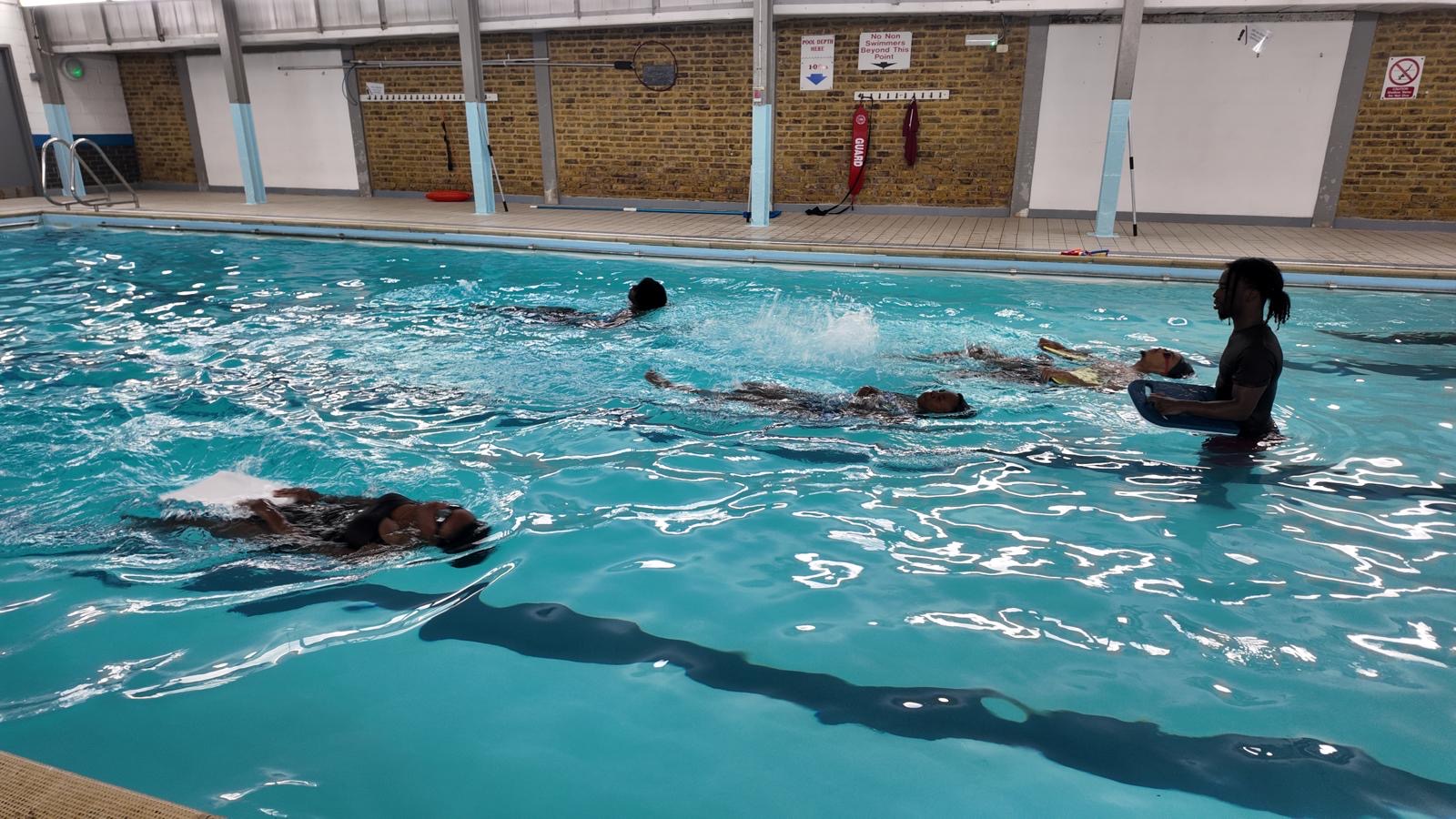 Aqua Jetz students practicing kicking technique with kickboards